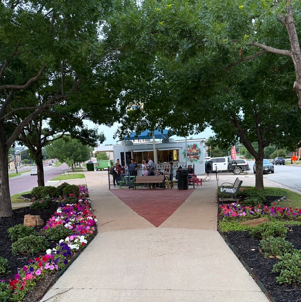Pop-Pop Feducchi’s trailer serving guests in a flower-lined Fort Worth park
